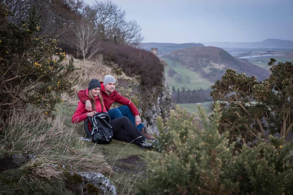 Fashion outdoor clothing photography, Scotland on location. Hiking shot at top of steep hill.