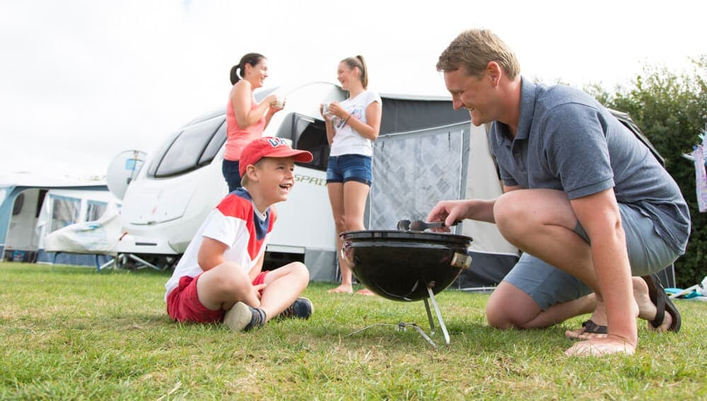 For this tourism photography project Tony wanted to involve happy campers in the foreground and background. He found a lovely family of “model campers” on the site in Cornwall.